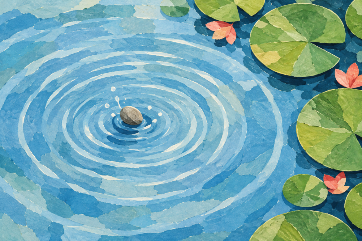 A pebble creating widening ripples in blue water beside green lily pads.